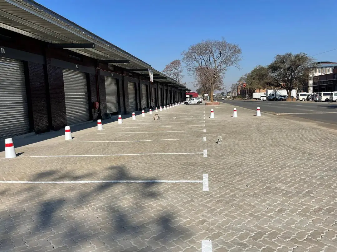 Completed paved parking bays alongside a commercial building