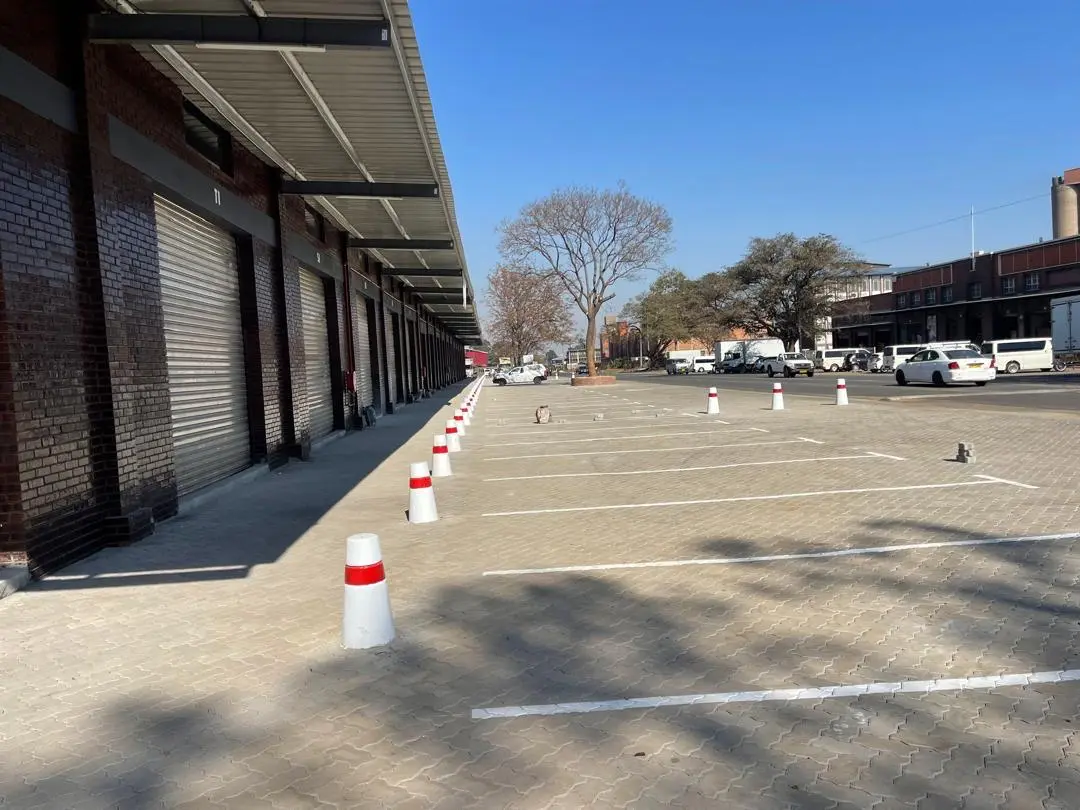Marked parking bays paved beside warehouse units